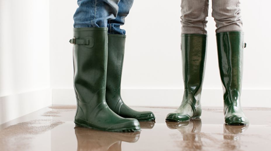 woman wading through water in wellies